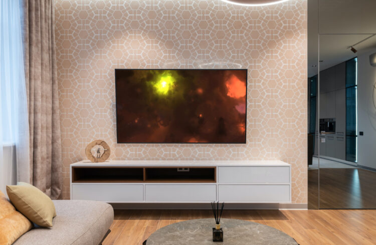 beige wall with mounted tv and photo of Galaxy photo